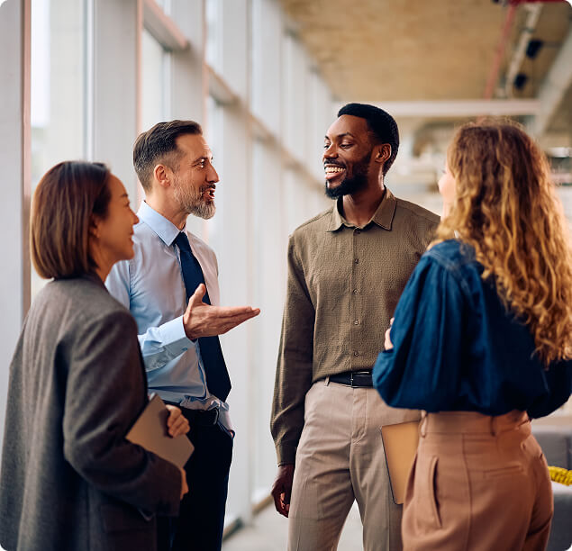 Diverse business leaders discussing executive coaching in modern office
