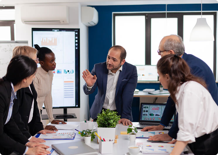Business team collaborating around a desk in a modern office
